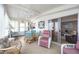 Well-lit sunroom featuring tile flooring, comfortable seating, and sliding doors to the living area at 170 Edgewood Dr, Osprey, FL 34229