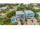Aerial view of bright, colorful, two-story house featuring a private pool, and brick driveway at 202 75Th St, Holmes Beach, FL 34217