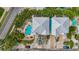 Aerial view of coastal home with a pool surrounded by lush landscaping and a light-colored roof at 202 75Th St, Holmes Beach, FL 34217