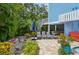 Landscaped backyard featuring spiral staircase, outdoor seating, lush plants, and entertainment at 202 75Th St, Holmes Beach, FL 34217