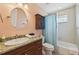 This well-lit bathroom includes a vanity with granite counters and a shower/tub at 202 75Th St, Holmes Beach, FL 34217
