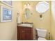 Cozy bathroom with granite countertops, decorative mirror and lighting, and unique octagon window at 202 75Th St, Holmes Beach, FL 34217