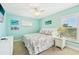 Bright bedroom features a ceiling fan, carpeted floors and coastal inspired decor with lots of natural light at 202 75Th St, Holmes Beach, FL 34217