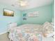 This well-lit bedroom offers great natural light, ceiling fan, and a tv for your enjoyment at 202 75Th St, Holmes Beach, FL 34217