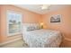This light and bright bedroom has a window, ceiling fan and serene beachy theme at 202 75Th St, Holmes Beach, FL 34217