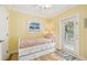 Bedroom featuring hardwood floors, closet, a comfortable bed, ceiling fan and exterior access at 202 75Th St, Holmes Beach, FL 34217