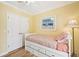 This bedroom offers hardwood floors, a ceiling fan, closet and comfortable bed at 202 75Th St, Holmes Beach, FL 34217