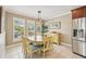 Dining area featuring tile flooring, stainless steel appliances, and plantation shutters at 202 75Th St, Holmes Beach, FL 34217