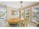 Dining room with decorative lighting, neutral walls, plantation shutters, and an oval table at 202 75Th St, Holmes Beach, FL 34217