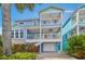 Charming two-story house featuring lush landscaping, inviting balconies, and easy garage access at 202 75Th St, Holmes Beach, FL 34217