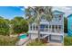 Beautiful two-story house featuring lush landscaping, a private pool, and inviting balconies on both floors at 202 75Th St, Holmes Beach, FL 34217