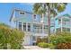 Exterior of a coastal home featuring a two-story design with a private balcony and serene blue siding at 202 75Th St, Holmes Beach, FL 34217