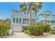 Charming two-story house with a lush garden, a driveway, and inviting balconies on both floors at 202 75Th St, Holmes Beach, FL 34217