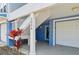 Coastal home exterior with stairs leading to the entry; features vibrant blue siding and a garage at 202 75Th St, Holmes Beach, FL 34217