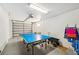 Finished garage space includes table tennis and an open door with storage on the sidewall at 202 75Th St, Holmes Beach, FL 34217