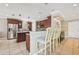 Open kitchen area featuring an island with seating, granite counters, and stainless steel appliances at 202 75Th St, Holmes Beach, FL 34217