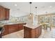 Spacious kitchen with a center island, granite countertops, and stainless appliances at 202 75Th St, Holmes Beach, FL 34217