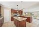 Well-equipped kitchen features a central island, granite countertops, and wood cabinetry at 202 75Th St, Holmes Beach, FL 34217