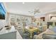 Bright living room with a view into the kitchen, tile floors, and comfortable seating at 202 75Th St, Holmes Beach, FL 34217