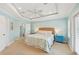 This main bedroom offers a tray ceiling, a fan, and a calm decor at 202 75Th St, Holmes Beach, FL 34217