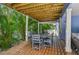 Covered outdoor patio features a dining table and seating perfect for entertaining at 202 75Th St, Holmes Beach, FL 34217