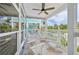 Outdoor covered patio includes seating for enjoying the tropical breeze at 202 75Th St, Holmes Beach, FL 34217