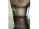 Shows an empty living room with dirty, aged floor and walls and a dated ceiling fan at 2026 Seminole S Blvd, St Petersburg, FL 33705