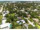Aerial view of a home with solar panels and a pool in a green neighborhood at 2460 Hillview St, Sarasota, FL 34239