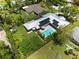 Aerial view of a house with a pool, solar panels, and landscaped yard at 2460 Hillview St, Sarasota, FL 34239