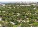 Expansive aerial view of the property with mature trees and solar panels on the roof at 2460 Hillview St, Sarasota, FL 34239