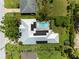 Aerial view of a modern home with a pool, solar panels, and well-manicured lawn at 2460 Hillview St, Sarasota, FL 34239