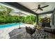 Serene backyard featuring a pool, patio seating, lush greenery, and shade for relaxation at 2460 Hillview St, Sarasota, FL 34239