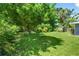 Expansive backyard with mature trees, a storage shed, and ample green space at 2460 Hillview St, Sarasota, FL 34239