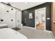 Elegant bathroom with a walk-in shower, freestanding tub, and striking black and white mosaic flooring at 2460 Hillview St, Sarasota, FL 34239