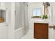 Bright bathroom featuring a white tiled shower, classic sink, and neutral accents at 2460 Hillview St, Sarasota, FL 34239