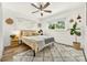 Cozy bedroom with bright, natural lighting, a ceiling fan, and light wood-look floors at 2460 Hillview St, Sarasota, FL 34239