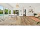 Open dining room with a view of the pool and garden from the sliding glass doors at 2460 Hillview St, Sarasota, FL 34239