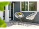 Inviting front porch with chairs, Zebra rug, and updated gray brick at 2460 Hillview St, Sarasota, FL 34239