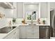 Bright kitchen with white cabinets, stainless steel appliances and a view of the garden at 2460 Hillview St, Sarasota, FL 34239