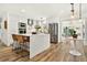 Bright kitchen featuring white cabinets, stainless steel appliances, and an island with seating at 2460 Hillview St, Sarasota, FL 34239