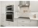 Bright modern kitchen features stainless steel appliances and white cabinets at 2460 Hillview St, Sarasota, FL 34239