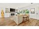 Comfortable living room with white fireplace, wood floors and large window at 2460 Hillview St, Sarasota, FL 34239