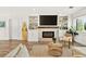 Modern fireplace and living room area with wood floors and surfboard at 2460 Hillview St, Sarasota, FL 34239