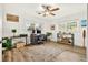 Bright home office features hardwood floors, a ceiling fan, and views from two windows overlooking the landscape at 2460 Hillview St, Sarasota, FL 34239