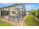 Fenced-in backyard features a screened-in pool, lush landscaping, and ample space for outdoor entertainment at 2710 93Rd E Ct, Palmetto, FL 34221