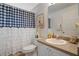 Bathroom featuring a toilet, sink, and bathtub with blue and white shower curtain at 2710 93Rd E Ct, Palmetto, FL 34221