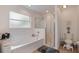 A bathroom featuring a soaking tub, glass shower, and toilet at 2710 93Rd E Ct, Palmetto, FL 34221