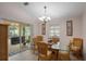 Bright dining room features wicker chairs, a glass table, and sliding glass doors leading to an outdoor patio area at 2710 93Rd E Ct, Palmetto, FL 34221