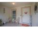 Cozy front porch featuring comfortable seating and welcoming decorations, perfect for enjoying the outdoors at 2710 93Rd E Ct, Palmetto, FL 34221