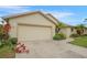 This image showcases the home's spacious two-car garage, complemented by a neatly landscaped front yard at 2710 93Rd E Ct, Palmetto, FL 34221